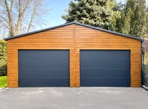 7x6m DELUX mobile garage/workshop/warehouse with gable roof, 2 sectional doors, door, 2 windows, skirting, guttering, horizontal cladding, double paint treated (black) frame structure