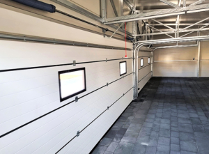 12x6m DELUX insulated workshop / warehouse / mobile garage with custom designed back sloping roof, 2 sectional doors, doors, 5 windows, cornices, guttering, plywood roof cladding, galvanized frame structure