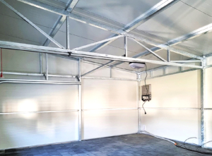 12x6m DELUX insulated workshop / warehouse / mobile garage with custom designed back sloping roof, 2 sectional doors, doors, 5 windows, cornices, guttering, plywood roof cladding, galvanized frame structure