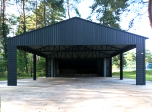 7x7m DELUX carport / tractor shed with gable roof, skirting, horizontal sheeting on the posts and vertical sheeting under the roof, double painted (black) frame structure