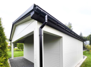 6x7,3m DELUX insulated mobile garage with gable roof, rear overhang, sectional door, door, window, skirting, gutter, galvanized frame