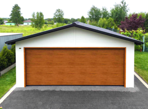 6x7,3m DELUX insulated mobile garage with gable roof, rear overhang, sectional door, door, window, skirting, gutter, galvanized frame