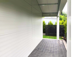 6x7,3m DELUX insulated mobile garage with gable roof, rear overhang, sectional door, door, window, skirting, gutter, galvanized frame